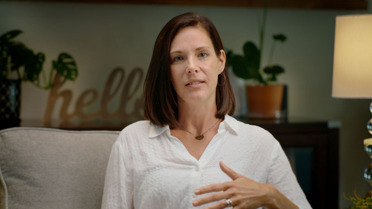 An instructor mid-sentence on a couch, filming a course session.